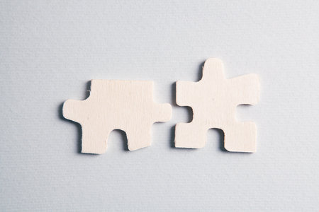 White puzzle pieces on the tableの写真素材