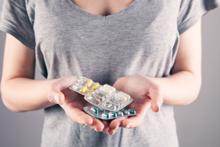 woman hand holding pillsの写真素材