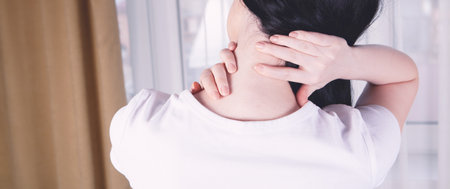 close-up on a woman's hand massaging her neck. Girl's neck hurtsの写真素材