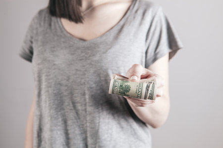 girl holding big money in her handsの写真素材