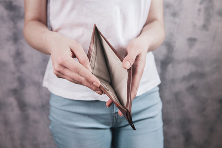 girl holds an empty wallet in his hands.