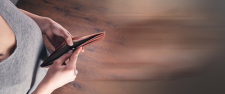 girl holds an empty wallet in his hands.