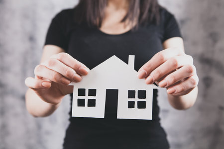 Family care and protection insurance concept. model of a small houseの写真素材