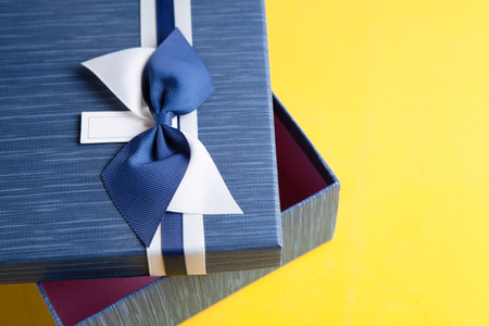 Gift box wrapped in kraft paper and bowの写真素材