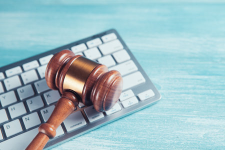 Close up view of a hammer and a computer keyboard.の写真素材