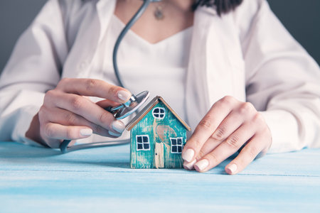 the doctor put the stethoscope to the houseの写真素材