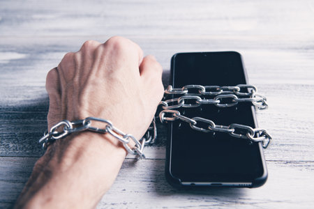 telephone with hand tied with chain