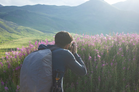 the photographer takes pictures of flowers in the mountains