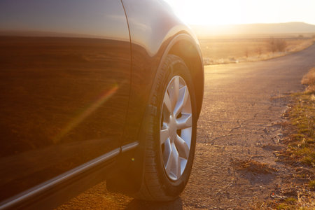 the car is on the road near the fieldsの写真素材
