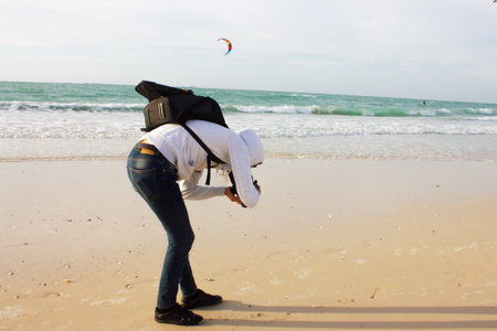 man taking pictures on the beach
