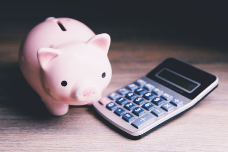 piggy bank and calculator on the tableの写真素材