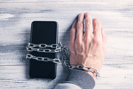 hand tied in a chain with a telephoneの写真素材