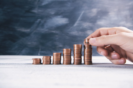 hand puts coins in the form of a growing graph