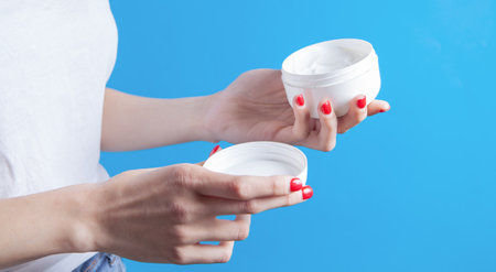 young girl holding hand creamの写真素材