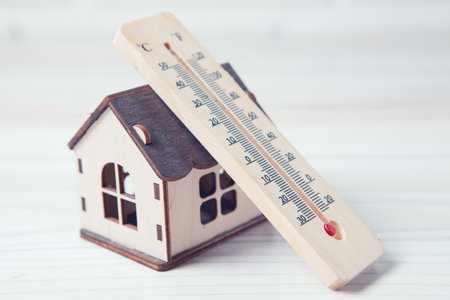 house and thermometer on the tableの写真素材