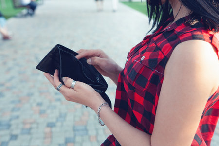 woman holding empty wallet in the streetの写真素材