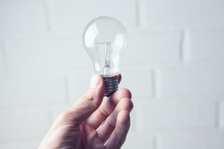 hand holding a lightbulb