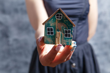 young girl holding a houseの写真素材