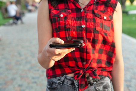 young woman holding wallet in the parkの写真素材