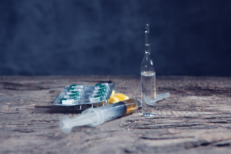 pills, ampoule and syringe on the tableの写真素材