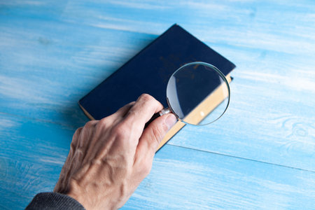 magnifying glass looking at a bookの写真素材