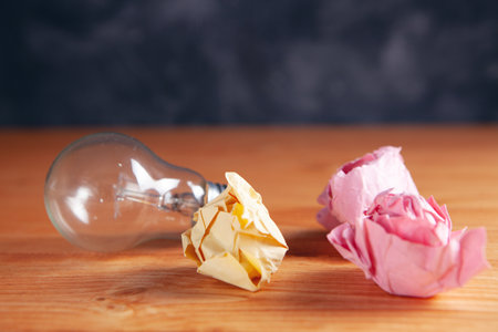 crumpled papers and a light bulb on the table