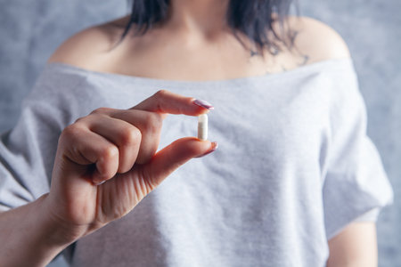 young woman holding a capsuleの写真素材