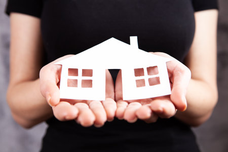 young girl holding a houseの写真素材