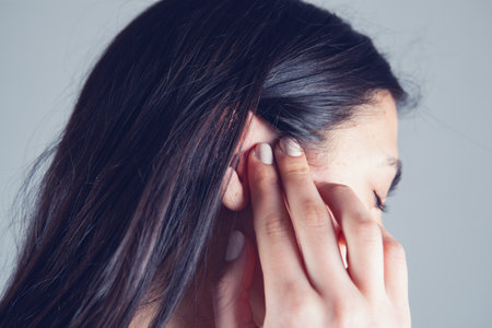 a young girl has an ear acheの写真素材