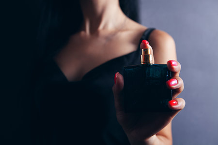 woman holding a bottle of perfumeの写真素材