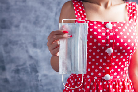 young girl holding medical mask