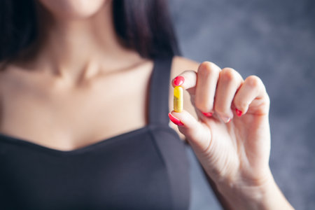 young woman holding a capsuleの写真素材
