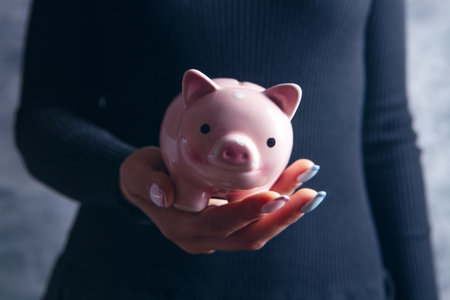 young girl holding a piggy bankの写真素材