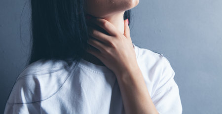 a young girl has a neck acheの写真素材
