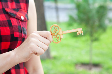 girl holding keys in the park