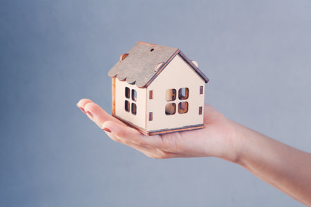 young girl holding a houseの写真素材