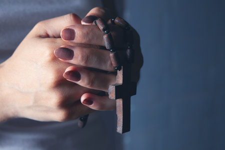 young woman holding a wooden cross