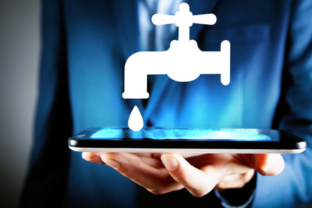 man holding tablet with illustrated water tapの写真素材