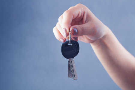 woman's hand holding the keys to the door