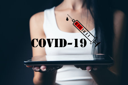 woman holding a tablet. covid-19 vaccinationの写真素材