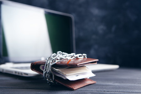 wallet closed with chain and laptopの写真素材