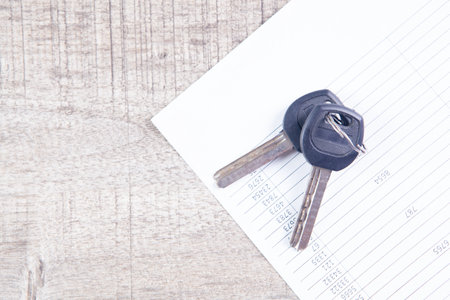 paper and keys on the tableの写真素材