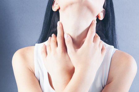 a young girl has a sore throatの写真素材