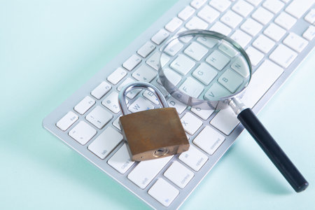 on the keyboard a magnifier and a lock. security search conceptの写真素材