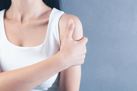 young woman has shoulder painの写真素材