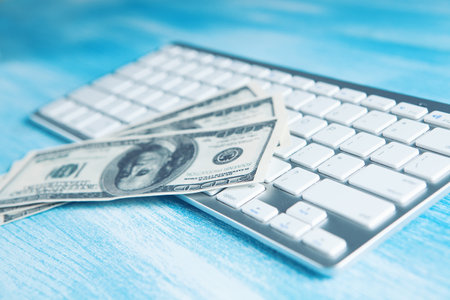 dollar bills on the keyboardの写真素材