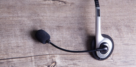 headphones with microphone on wooden backgroundの写真素材