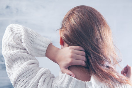 a young girl has a neck acheの写真素材