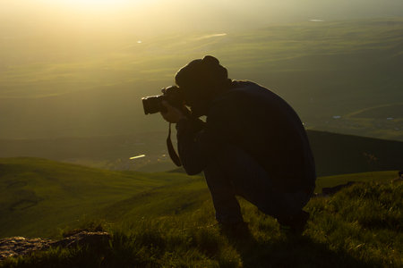 the photographer takes pictures on the mountain
