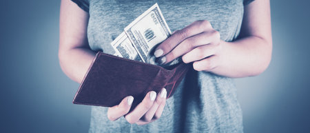 a young girl pulls out bills from a wallet